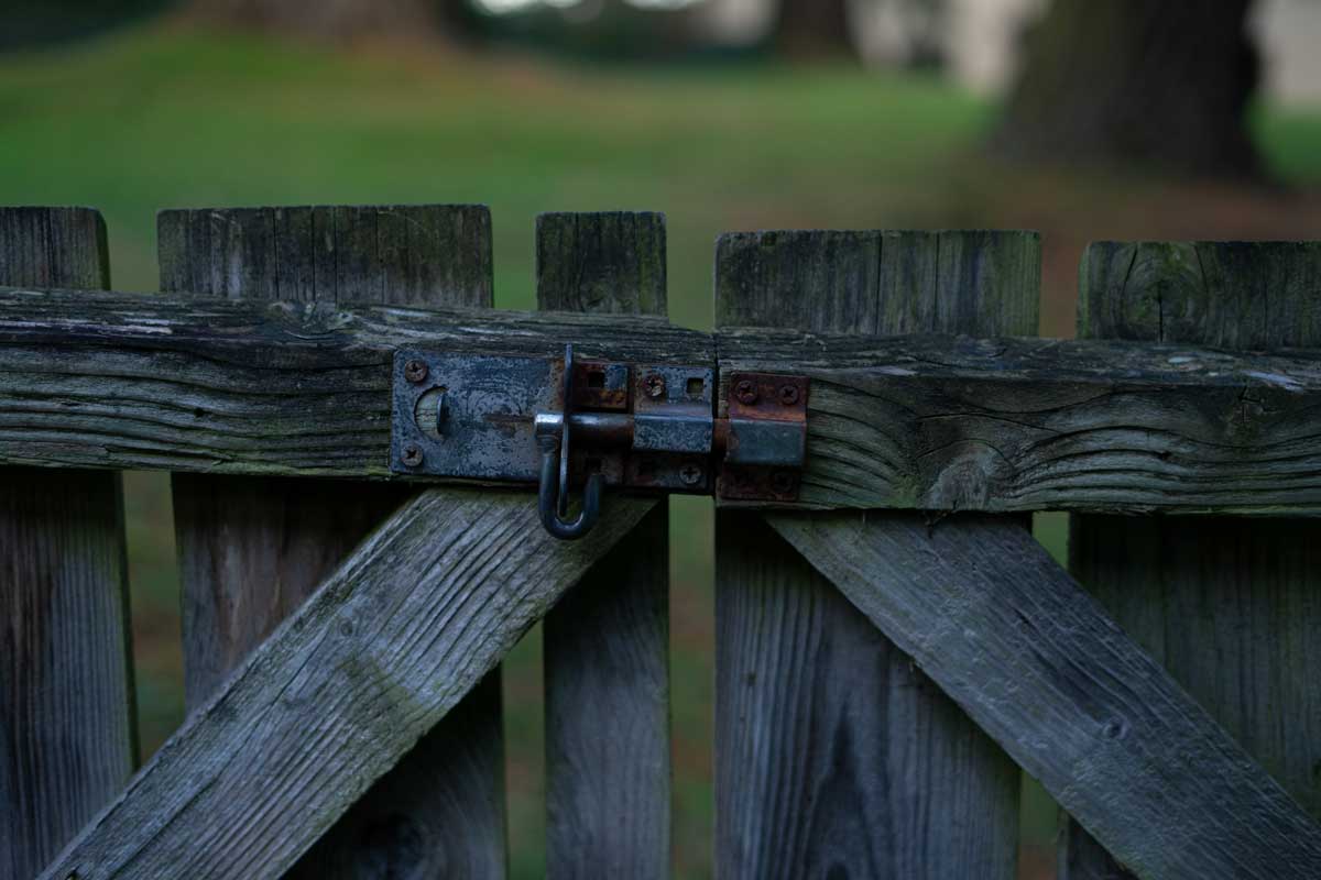 An olden, wooden gate painted dark blue