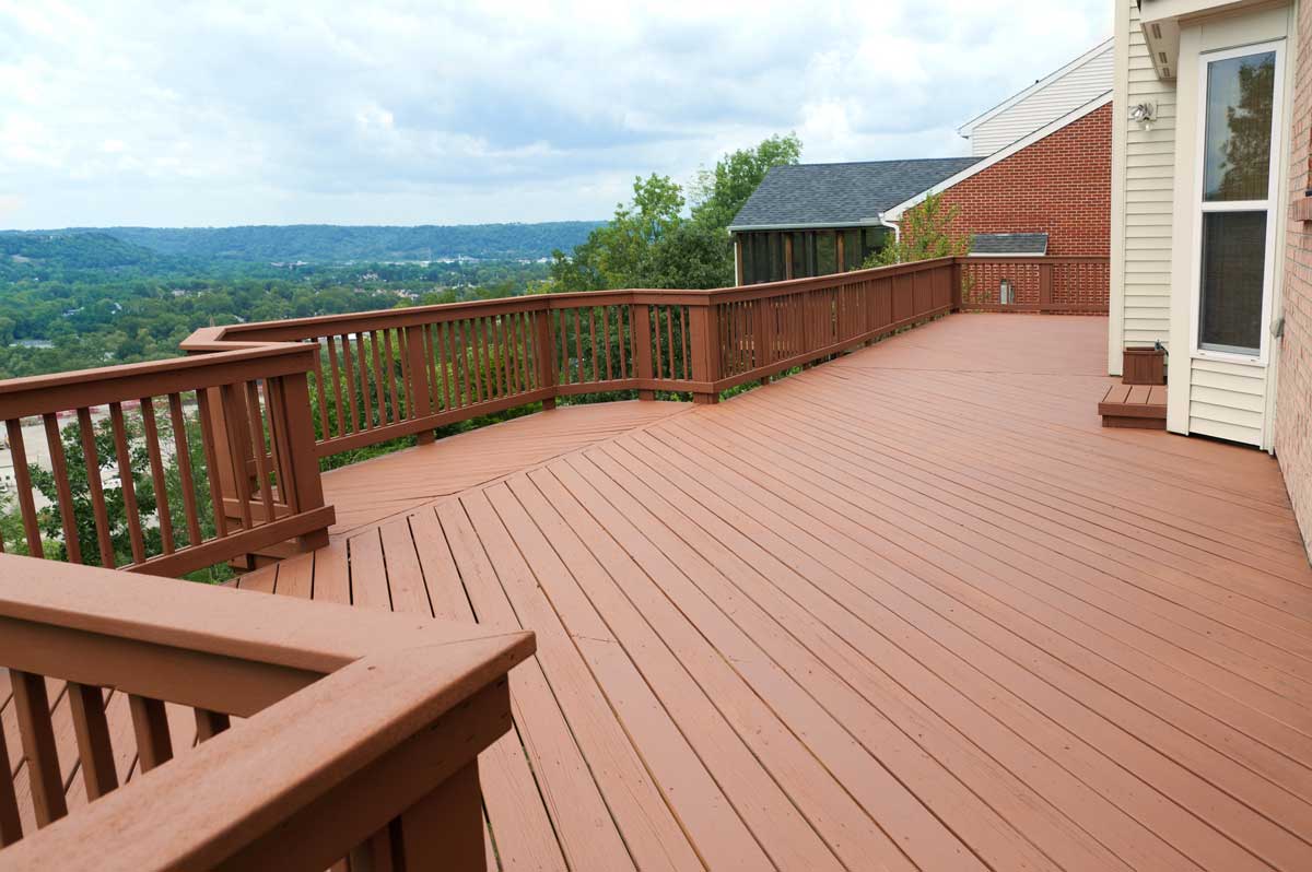 An expansive wooden deck overlooking hills in the distance