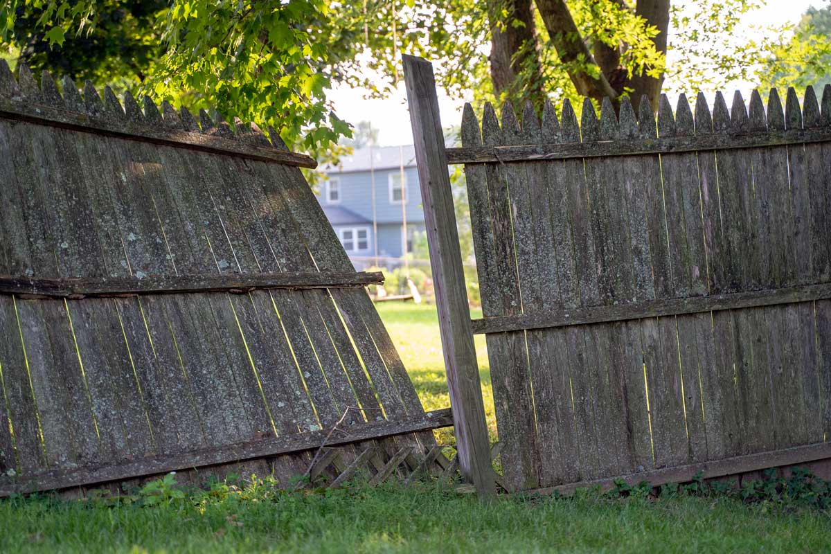 An old wooden fence half-collapsed and split apart